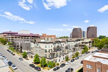 Exterior aerial view of the mirabelle luxury apartments with street parking and parking garage access, close to public transportation.
